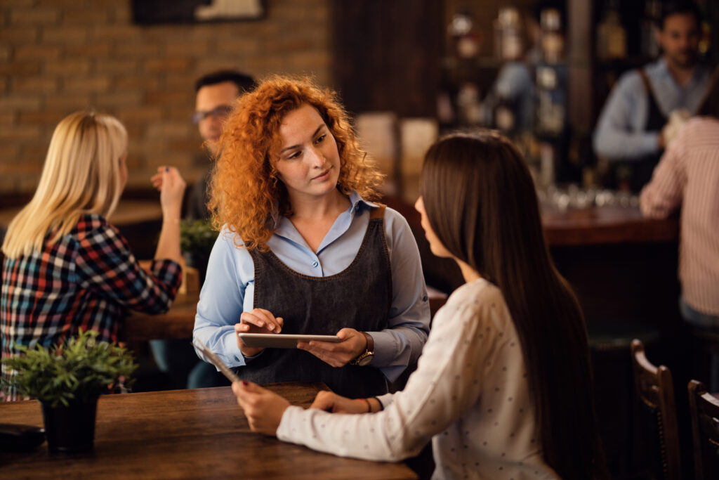 Restaurant server taking orders for peak season dining.