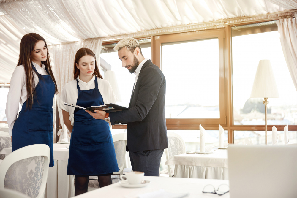 Manager giving feedback to a hospitality recruit.