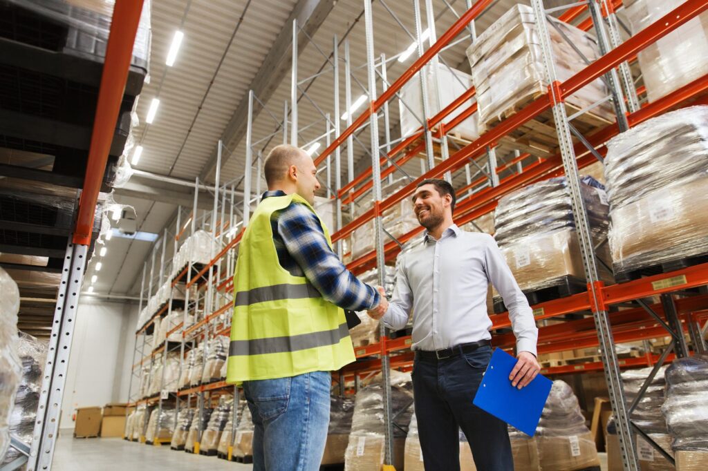 Manufacturing worker smiling, post successful manufacturing recruitment