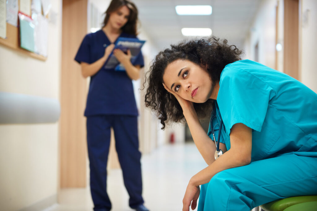 Exhausted nurse emphasizing the challenges in recruiting for nurses