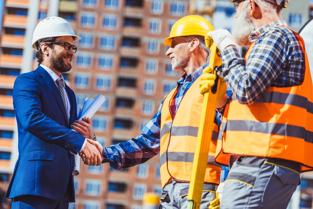 Handshake between a construction manager and a new hire