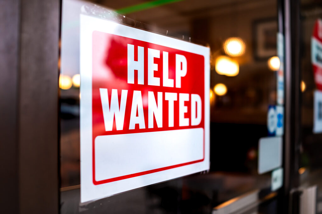 Help wanted sign in a retail store window