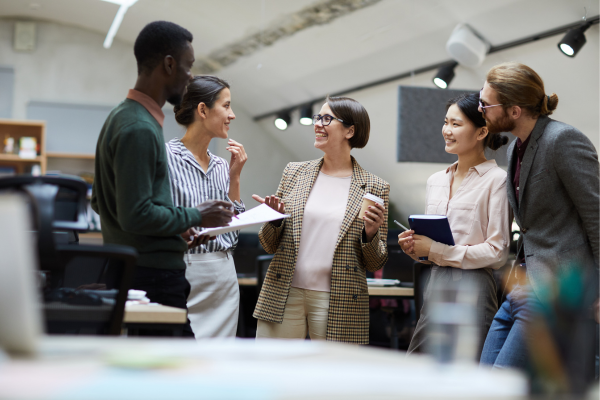 Diverse employees hanging out, representing reduced bias with data analytics in recruitment