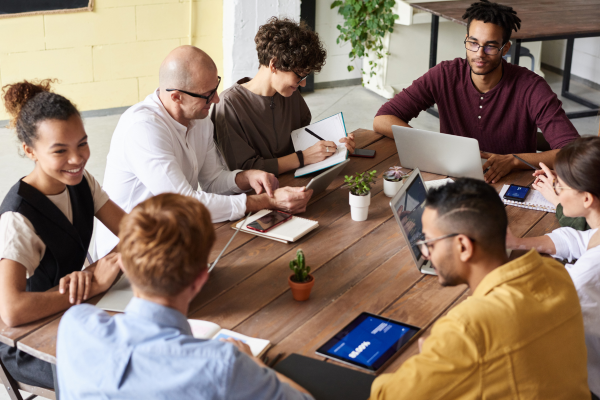 Diverse team collaborating in an office to enhance recruitment and retention.