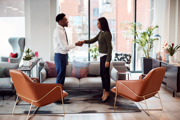  Interviewer and candidate handshake during an interview process focusing on retention in recruitment.