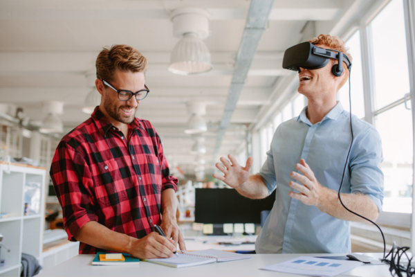 Employee receiving virtual reality training in the office, representing the latest trends in HR technology.