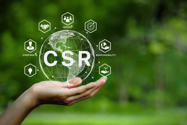 Hand holding CSR graphic representing corporate social responsibility with icons for social, environmental, and ethical practices.