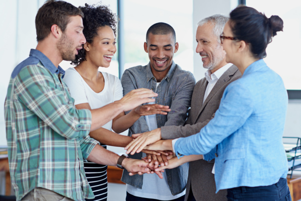 A diverse team collaborating in an office environment, showcasing the importance of diversity and inclusion in hiring.