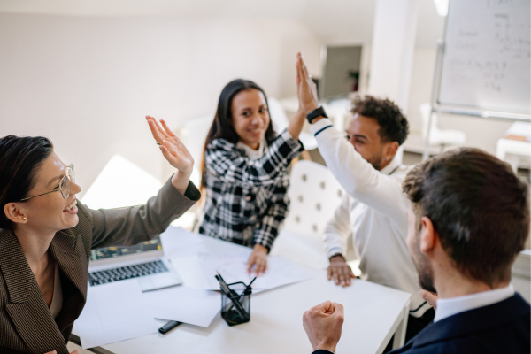 A team celebrating successful employer branding, demonstrating the positive effects of strong online job recruiting strategies.