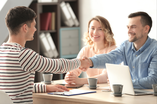 Candidate shaking hands after a successful interview for a light industrial role.