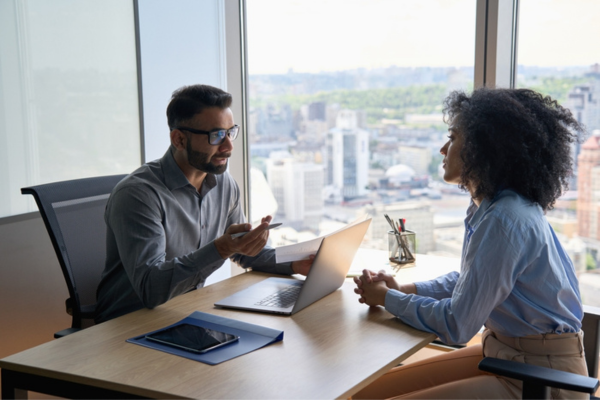 Recruiter discussing job opportunities with a candidate using candidate relationship management tools.