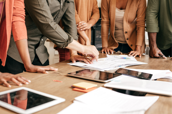 A team collaborating on social media recruitment strategy to engage with candidates across platforms like LinkedIn and Twitter.